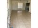 Spacious living room with tiled floors, large window and view to an open-plan kitchen at 3347 E Palm Ln, Phoenix, AZ 85008