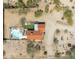 Overhead shot of property with a private pool, lounge area, red tile roof, and desert vegetation at 33810 N Smokehouse Trl, Cave Creek, AZ 85331