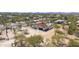 Aerial view showcasing a home with a terracotta roof, a swimming pool, and desert landscaping in a serene neighborhood at 33810 N Smokehouse Trl, Cave Creek, AZ 85331
