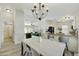 Bright dining room with a modern chandelier and open access to the kitchen and living areas at 33810 N Smokehouse Trl, Cave Creek, AZ 85331