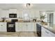Bright kitchen with white cabinets and modern black appliances at 33810 N Smokehouse Trl, Cave Creek, AZ 85331