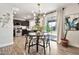 Bright dining area with modern lighting, sliding glass doors, and open kitchen access at 34505 N Picket Post Dr, San Tan Valley, AZ 85144