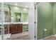 Stylish bathroom featuring wood-look tile, glass enclosed shower, and ample counter space at 39758 N Hailey Ln, Queen Creek, AZ 85140
