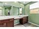 Bright bathroom featuring double sinks, wood cabinets, and a vanity space with great natural lighting at 39758 N Hailey Ln, Queen Creek, AZ 85140