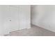 Bedroom with gray carpet, double sliding door closet, and white walls for a clean design at 39758 N Hailey Ln, Queen Creek, AZ 85140