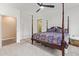 Well-lit bedroom featuring carpet, a four-poster bed, and an ensuite bathroom at 39758 N Hailey Ln, Queen Creek, AZ 85140