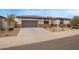 A cozy single-story house with a two-car garage, long driveway, and low maintenance yard at 39758 N Hailey Ln, Queen Creek, AZ 85140