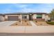 Inviting single-story home with a two-car garage and low maintenance desert landscaping at 39758 N Hailey Ln, Queen Creek, AZ 85140