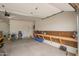 Open garage with a workbench, storage shelves, and ample space for parking and projects at 39758 N Hailey Ln, Queen Creek, AZ 85140