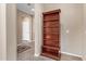 Hallway with hardwood style floors, decorative area rug, and large shelving unit at 39758 N Hailey Ln, Queen Creek, AZ 85140