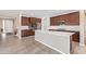 Spacious kitchen featuring a large center island, stainless steel appliances, and wood-look floors at 39758 N Hailey Ln, Queen Creek, AZ 85140