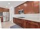 Elegant kitchen showcasing stainless steel appliances, ample cabinetry, and quartz countertops at 39758 N Hailey Ln, Queen Creek, AZ 85140