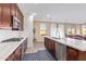 Open-concept kitchen featuring a large island, stainless steel appliances, and seamless flow to living area at 39758 N Hailey Ln, Queen Creek, AZ 85140