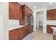 Well-equipped kitchen with stainless steel appliances, wood cabinets, and walk-in pantry access at 39758 N Hailey Ln, Queen Creek, AZ 85140