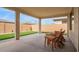 Inviting covered patio with artificial grass, ideal for outdoor relaxation and entertaining at 39758 N Hailey Ln, Queen Creek, AZ 85140