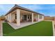 Outdoor patio featuring artificial grass and multiple seating options, great for gatherings and relaxation at 39758 N Hailey Ln, Queen Creek, AZ 85140