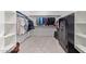 Walk-in closet featuring custom shelving, hanging rods, carpet, and a storage safe at 39758 N Hailey Ln, Queen Creek, AZ 85140