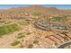 Enjoy stunning aerial views of the golf course, clubhouse, tennis courts, and lush desert landscape at 41105 N Prestancia Way, Anthem, AZ 85086