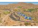 An aerial view showcases the community amenities including tennis courts, golf course, and clubhouse at 41105 N Prestancia Way, Anthem, AZ 85086