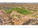 Aerial view of a lush golf course community, complete with mature trees and a small lake at 41105 N Prestancia Way, Anthem, AZ 85086