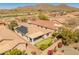 Overhead view showcasing the solar panels, putting green, covered patio, and mountain views in this active adult community at 41105 N Prestancia Way, Anthem, AZ 85086