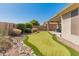 Well maintained backyard with a putting green, drought resistant landscaping, and a covered patio at 41105 N Prestancia Way, Anthem, AZ 85086