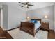 Comfortable bedroom featuring wood floors, ceiling fan, and a cozy rug at 41105 N Prestancia Way, Anthem, AZ 85086