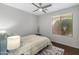 Bedroom with a window and ceiling fan offers a comfortable and bright space at 41105 N Prestancia Way, Anthem, AZ 85086