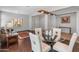 Bright dining area with wood floors, and a modern light fixture at 41105 N Prestancia Way, Anthem, AZ 85086