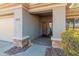 Inviting front door with covered porch and stone accents, creating a welcoming entrance to the home at 41105 N Prestancia Way, Anthem, AZ 85086
