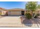 Charming single-story home with a well-manicured front yard and a two-car garage in a tranquil neighborhood at 41105 N Prestancia Way, Anthem, AZ 85086