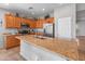 Spacious kitchen with granite countertops, stainless steel appliances, wood cabinets, and a large center island at 41105 N Prestancia Way, Anthem, AZ 85086