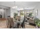Open-concept living area features sliding glass doors to the backyard, a ceiling fan, and comfortable seating at 41105 N Prestancia Way, Anthem, AZ 85086