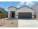 Charming single-story home featuring a red front door, two-car garage, and low-maintenance desert landscaping at 5123 E Umber Rd, San Tan Valley, AZ 85143