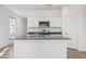 Bright kitchen with white cabinets, stainless steel appliances, and a granite countertop island at 5123 E Umber Rd, San Tan Valley, AZ 85143