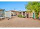 Spacious home backyard featuring a covered patio, gravel ground cover and mature trees at 520 N Ocotillo Dr, Apache Junction, AZ 85120