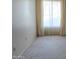 Bright, empty bedroom with neutral carpeting and a large window at 5518 E Lindstrom Ln # 1034, Mesa, AZ 85215