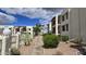 Well-maintained community walkway with landscaping and views of the condo buildings at 5518 E Lindstrom Ln # 1034, Mesa, AZ 85215
