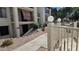 View of condo building with white picket fence and walkway with desert landscape at 5518 E Lindstrom Ln # 1034, Mesa, AZ 85215