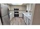 Modern kitchen with white cabinetry, stainless steel appliances, and light countertops at 5518 E Lindstrom Ln # 1034, Mesa, AZ 85215