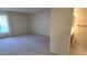 Bright living room featuring neutral carpeting and access to a bathroom at 5518 E Lindstrom Ln # 1034, Mesa, AZ 85215