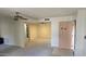 Living room with neutral carpet, ceiling fan, tile entryway, and closet at 5518 E Lindstrom Ln # 1034, Mesa, AZ 85215