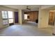 Spacious living room featuring neutral carpet, ceiling fan, and sliding doors to balcony at 5518 E Lindstrom Ln # 1034, Mesa, AZ 85215