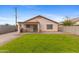 Charming backyard featuring a well-maintained lawn and a brick patio, perfect for outdoor entertaining at 5819 S 10Th St, Phoenix, AZ 85040