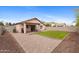 Spacious backyard with a manicured lawn, brick patio, and privacy wall, creating an inviting outdoor space at 5819 S 10Th St, Phoenix, AZ 85040