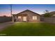 Private backyard featuring a well-maintained lawn, covered patio, and block fence at 5819 S 10Th St, Phoenix, AZ 85040