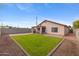 Private backyard offering a lush lawn and a covered patio ideal for outdoor entertaining and relaxation at 5819 S 10Th St, Phoenix, AZ 85040