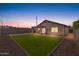 Private backyard featuring a well-maintained lawn, covered patio, and block fence at 5819 S 10Th St, Phoenix, AZ 85040