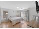 Bright bedroom featuring hardwood floors, white walls, and a minimalist aesthetic with lots of natural light at 5819 S 10Th St, Phoenix, AZ 85040