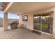 Covered patio includes stainless steel grill, tile flooring, and sliding glass door to the backyard at 5819 S 10Th St, Phoenix, AZ 85040
